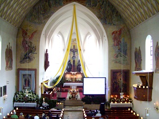 Foto vom Altarraum unserer Kirche im Kerzenlicht